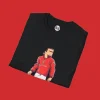 Close-up of black T-shirt showing detailed animated Eric Cantona in iconic red Manchester United number 7 shirt with collar up